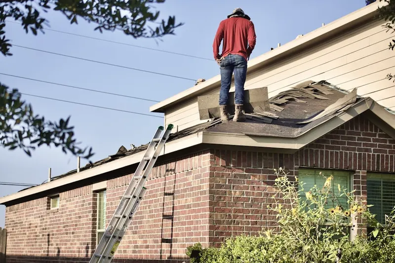 Professional roofer working on a residential roof in Kit Carson